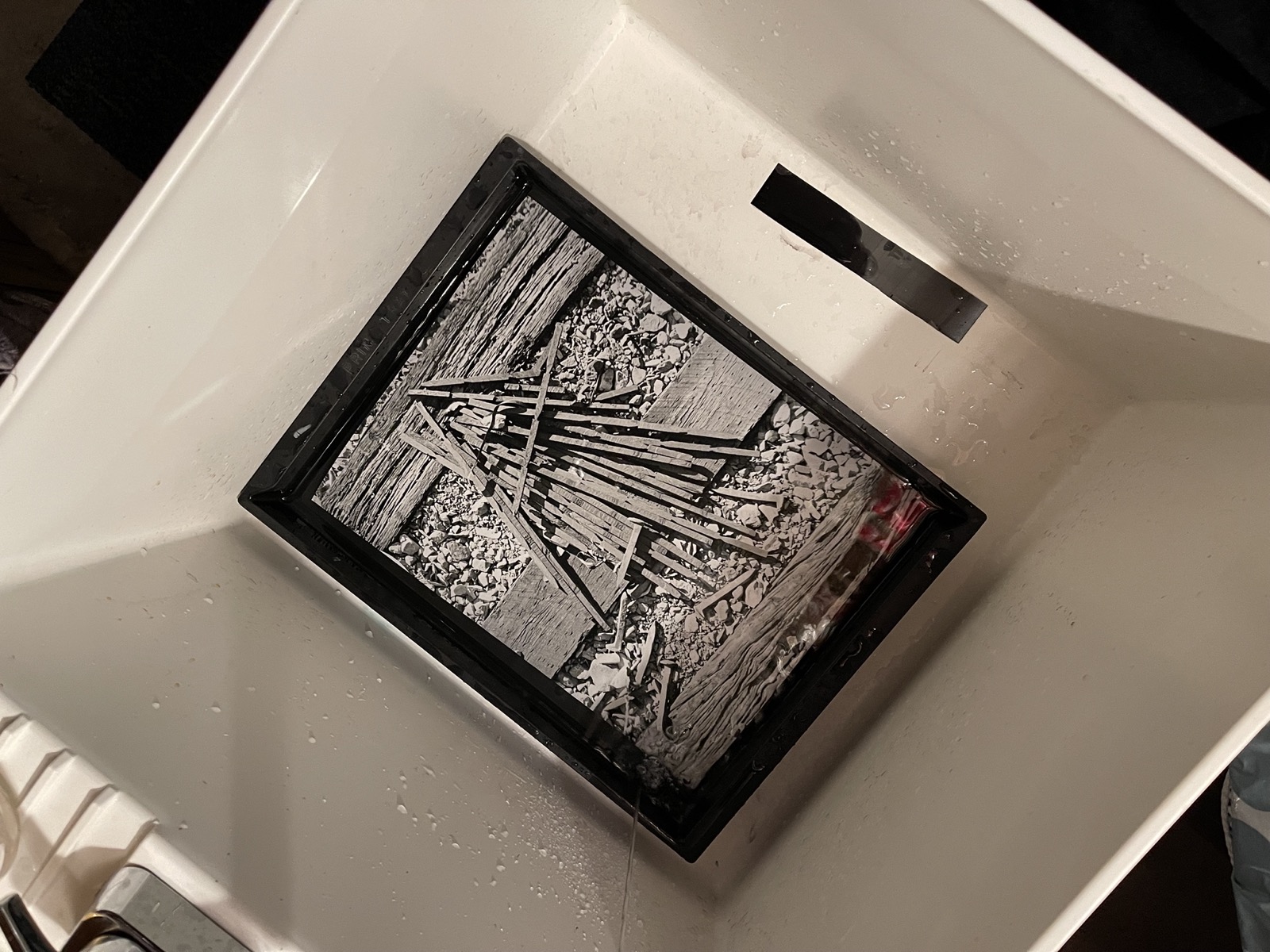 Print of railroad spikes in sink