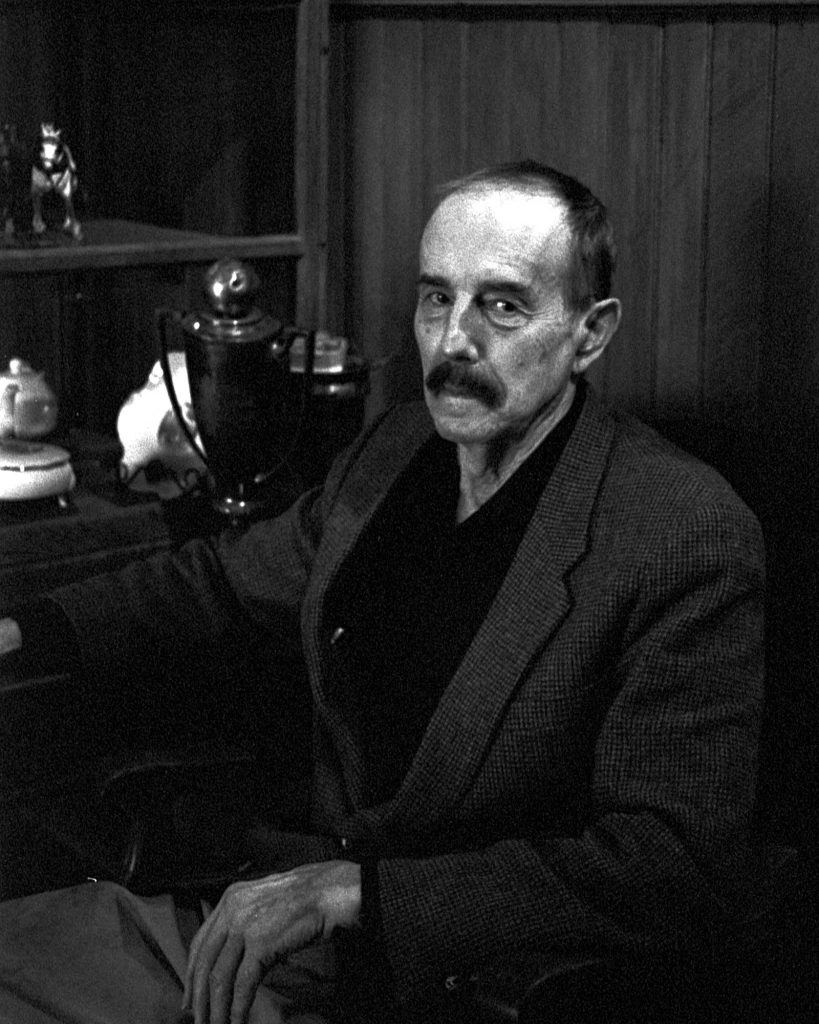 S. Robert Powell, Ph.D. at the Carbondale Historical Society sitting next to a few historical items.