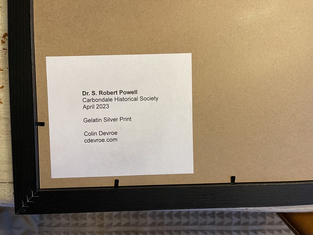 A white paper square on the back of the print reads: Dr. S. Robert Powell, Carbondale Historical Society, April 2023, Gelatin Silver Print and my name.
